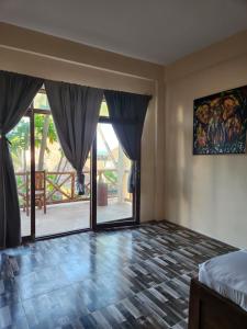 a bedroom with a bed and sliding glass doors at Two Palms in Jambiani