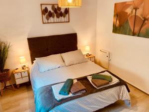 a bedroom with a bed with a tray on it at Mar De Cristal apartment 100 metres to the beach in Cartagena