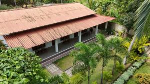 an aerial view of a building with a red roof at Swan Lake Habarana in Habarana