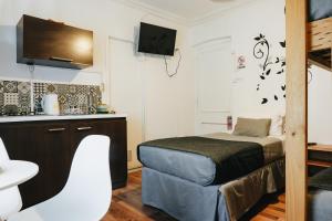 a small room with a bed and a sink at Apart hotel de Hostal Concepción in Concepción