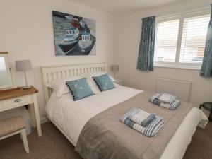 a bedroom with a bed with two pillows on it at Whitesands in Chathill