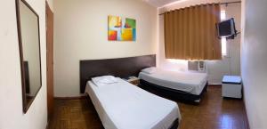 Säng eller sängar i ett rum på HOTEL TRES LAGOAS