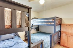 two bunk beds in a room with a bed at Boat Dock on Reelfoot Lake Tiptonville Retreat in Tiptonville