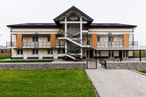 a large building with a staircase in front of it at Safari Hotel in Szeged