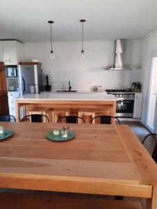 a kitchen with a wooden table with chairs and a kitchen counter at COLIBRI in Tandil