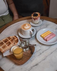 a table with a cup of coffee and a plate of food at HOTEL ARENALES in San Fernando del Valle de Catamarca