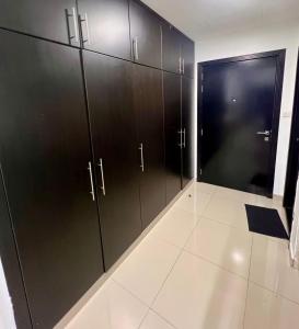 a locker room with black cabinets and a door at Studio Apartment near JBR in Dubai
