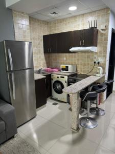 A kitchen or kitchenette at Studio Apartment near JBR