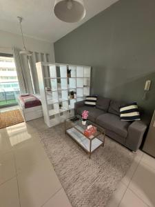 a living room with a couch and a coffee table at Studio Apartment near JBR in Dubai