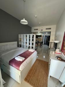a bedroom with a large bed and a desk at Studio Apartment near JBR in Dubai