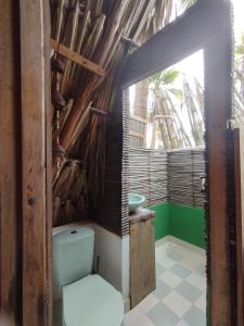 a bathroom with a toilet and a window at SakaNibue in San Bernardo del Viento