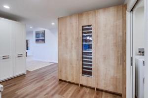 a kitchen with wooden cabinets and a refrigerator at Point Loma Serenity in San Diego