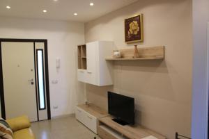 a living room with a flat screen tv on a wall at Villa CasArte in Bari