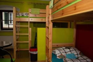 a bedroom with two bunk beds with green walls at Hostel Bad Goisern in Bad Goisern