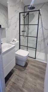 y baño con aseo, lavabo y ducha. en Star London Finchley Lane 3-Bed Residence with Garden, en Hendon