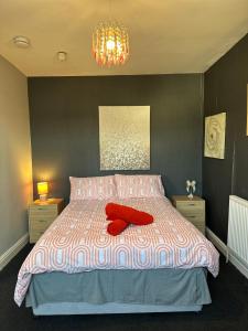 a bedroom with a bed with two red pillows on it at Winter Gardens Flat 4 Tower view family apartment in Blackpool