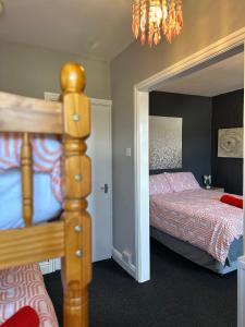 a bedroom with a bunk bed and a mirror at Winter Gardens Flat 4 Tower view family apartment in Blackpool