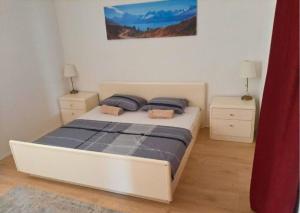 a bedroom with a bed with two night stands and two lamps at Holiday Apartment Nina,Zadar in Zadar
