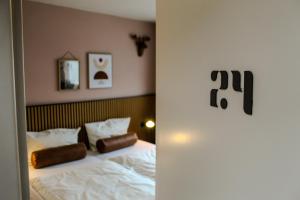 a bedroom with a bed with two pillows on it at Airport Hotel Jägerhof Weeze in Weeze