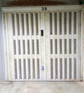 a white door with white shutters on it at 0541 Guest House Rimini in Rimini