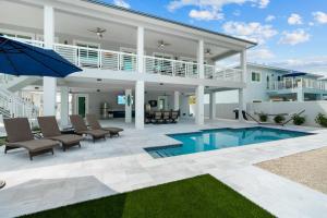 a villa with a swimming pool and a patio at Luna Light ~ Waterfront ~ Pool ~ Dock ~ Views in Marathon +65 photos