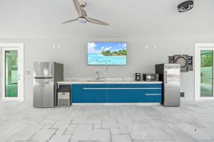 a kitchen with a blue counter and a ceiling at Luna Light ~ Waterfront ~ Pool ~ Dock ~ Views in Marathon