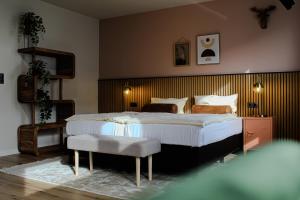 a bedroom with a large bed and a chair at Airport Hotel Jägerhof Weeze in Weeze