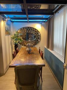 uma sala de jantar com uma mesa de madeira e um espelho em Crystal Loft Luxury Milano em Milão