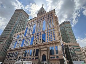 a building with a clock tower on top of it at Al Safwah Hotel First Tower in Makkah