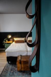 a bedroom with a bed and a blue wall at Airport Hotel Jägerhof Weeze in Weeze
