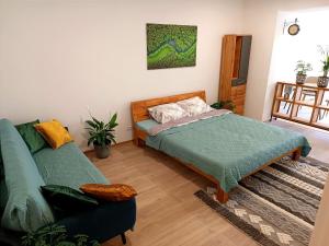 a bedroom with a bed and a couch at Gasthaus Tauchen with kitchen in Mönichkirchen