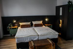 a bedroom with a large bed and two tables at Airport Hotel Jägerhof Weeze in Weeze