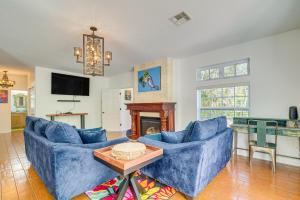 a living room with two blue couches and a fireplace at Decks, Docks and Kayaks Waterfront Homosassa Gem in Homosassa