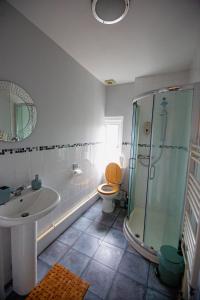 a bathroom with a sink and a shower and a toilet at George Street Apartment in Salisbury