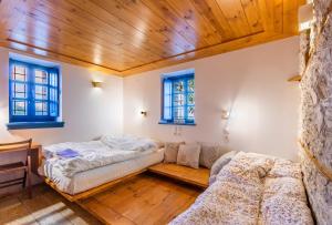 a bedroom with a bed and a couch at The Land Beyond in Vitsa