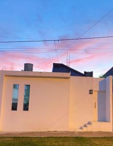 a white house with the sky in the background at Sarmiento 595 in Paso de los Libres