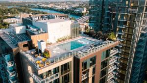 an aerial view of a building with a swimming pool on top at Luxury 2BR Rooftop Pool Austin by Barclé in Austin