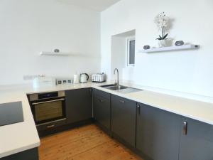 a kitchen with a sink and a counter top at Cadair Idris in Criccieth
