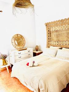 a bedroom with a large bed and a dresser at EDEN GARDEN b&b in Ponferrada
