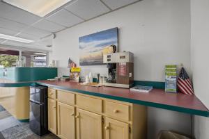 a kitchen with a counter with a coffee machine at Oasis Hotel in Myrtle Beach