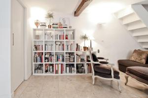a living room with a book shelf filled with books at Saint-Germain-des-Pr&eacute;s in Paris in Paris