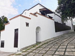 a white building with a door on the side at Room in Lodge - Cozy Room With Terrace in Mexico City