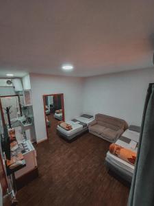 a room with two beds and a couch and a mirror at Value Place in Wadi Musa