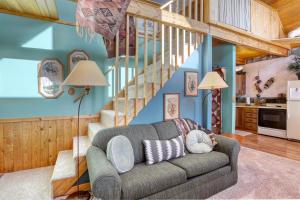 a living room with a couch and a staircase at Cozy Black Hills Retreat in Lead