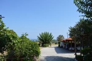 a parking lot with cars parked next to a building at Nikos & Panagiota in Vourvourou