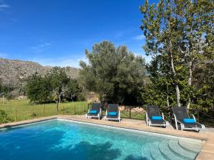 a group of chairs and a swimming pool at Villa Estel - La Goleta Hotel de Mar & Villas in Pollença