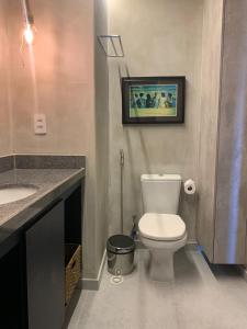 a bathroom with a white toilet and a sink at Eco Resort - Praia dos Carneiros - ao lado da Igrejinha in Rio Formoso