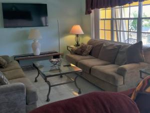 a living room with a couch and a table at Beach Paradise with Pool and Boating Dock in Freeport