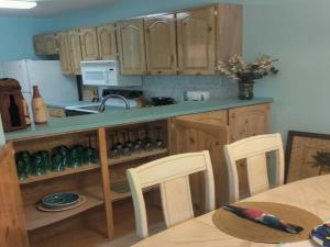 a kitchen with wooden cabinets and a table with chairs at Beach Paradise with Pool and Boating Dock in Freeport