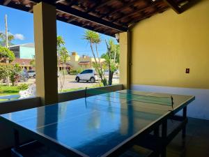 a ping pong table in a room with a window at Hotel Roma in São Sebastião